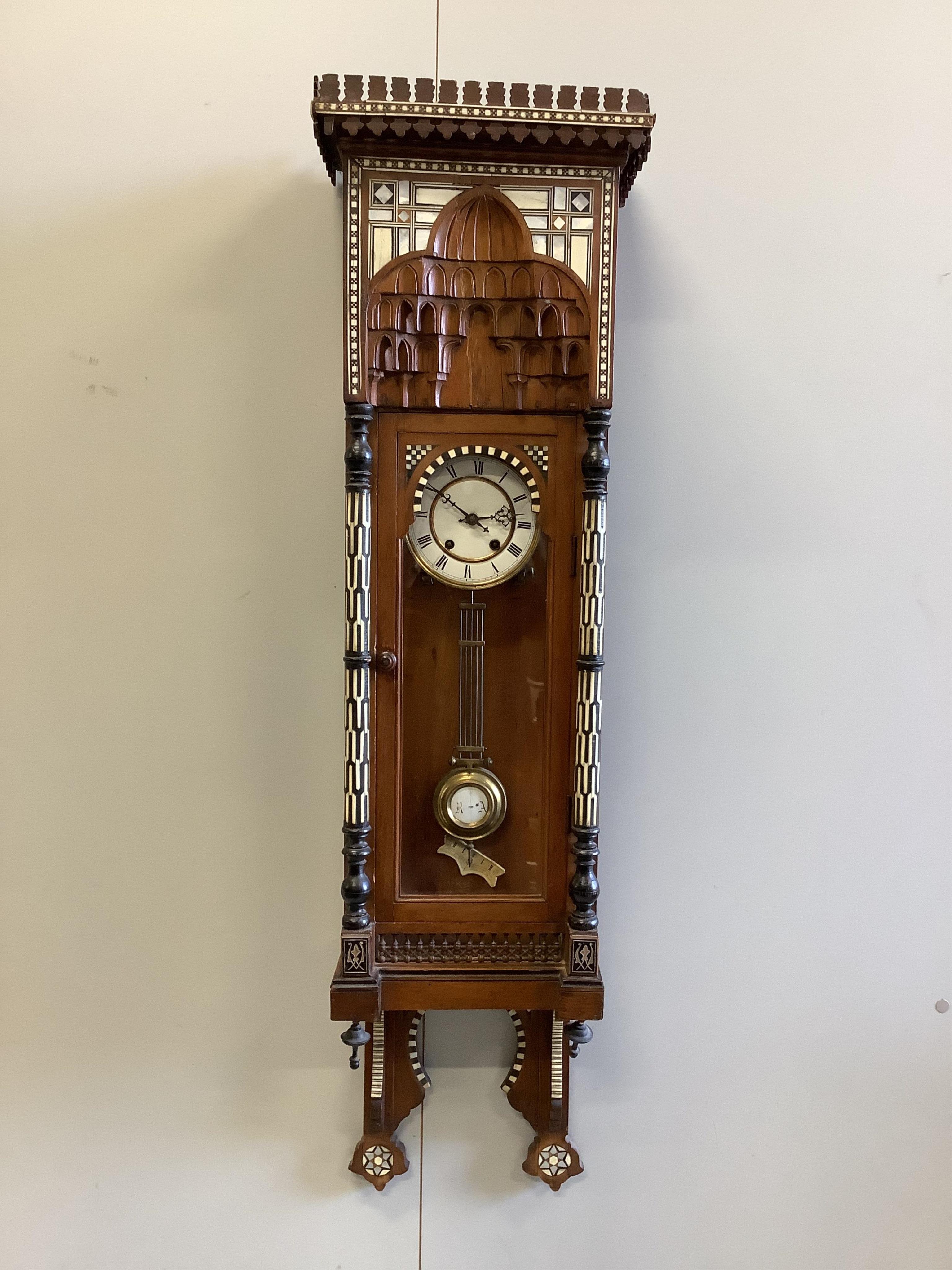 A Moorish style bone, ebony and mother of pearl inlaid wall clock, height 118cm. Condition - fair